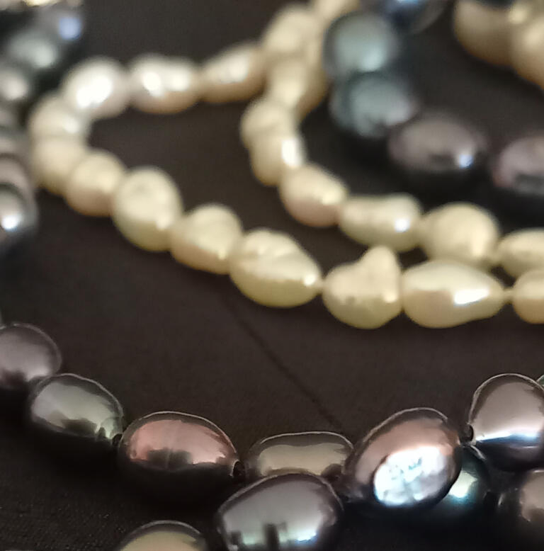 Several freshwater pearl necklaces in various colours knotted using traditional threading technique. Several freshwater pearl necklaces in various colours knotted using traditional threading technique.